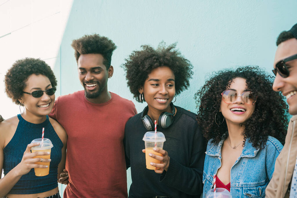 Portrait of multi-ethnic group of friends having fun together and enjoying good time while drinking fresh fruit juice.  - 写真・画像