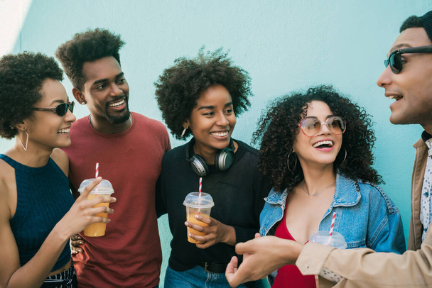 Portrait of multi-ethnic group of friends having fun together and enjoying good time while drinking fresh fruit juice.  - Photo, Image