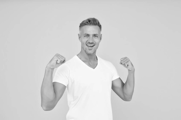 Strength and power. Happy bachelor show strength. Strong man flex arms yellow background. Strength and confident. Strength comes from within - Foto, afbeelding