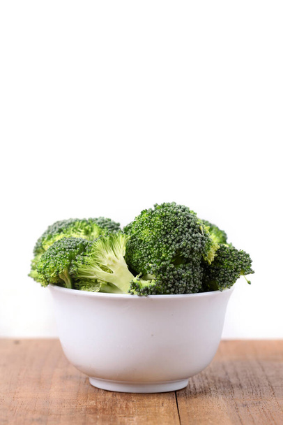 Fresh broccoli in a bowl. Isolated on white background with copyspace - Zdjęcie, obraz
