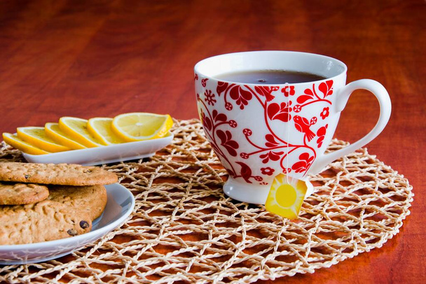 Tea with biscuits prepared on a wooden table. - Photo, Image