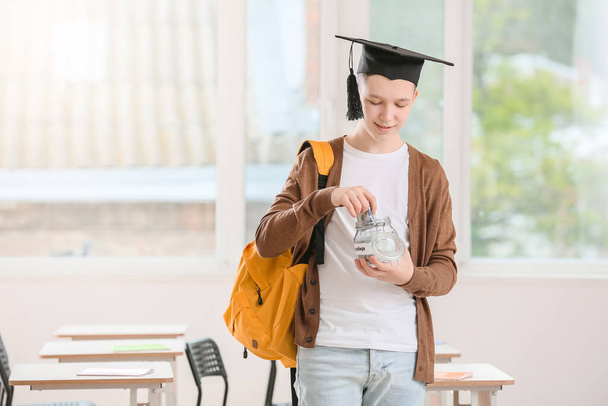Teenage boy with savings for education in class room - Fotografie, Obrázek