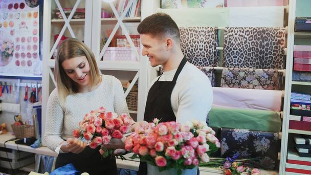 Young couple work at flower shop. - Φωτογραφία, εικόνα