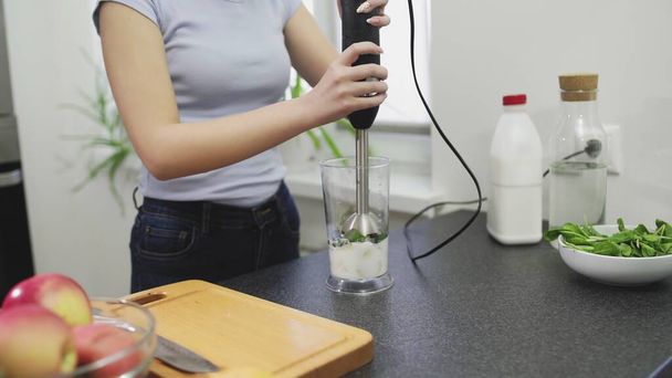 Woman is making the smoothie with milk in blender - Photo, image