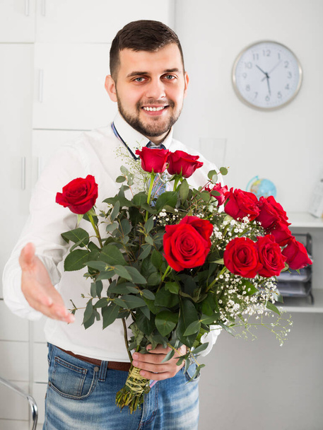 Gentleman is presenting flowers and gift during romantic date.  - Фото, зображення