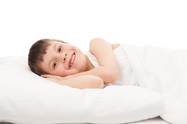 cheerful boy in white bed - 写真・画像