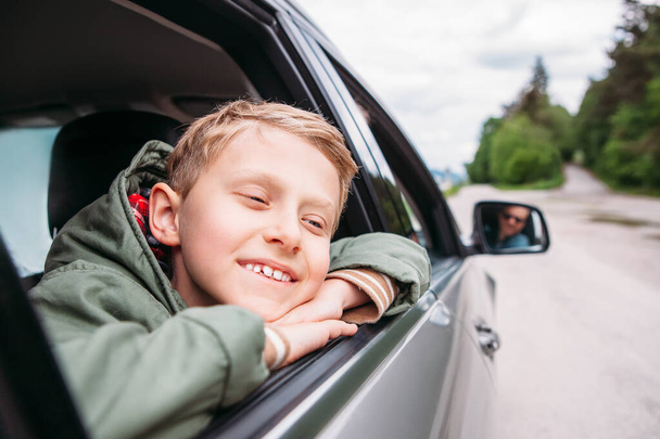 Мечтающий мальчик выглянет из окна машины
 - Фото, изображение