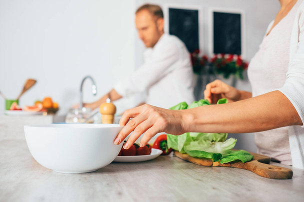 Couple on kitchen cooks together - Foto, Imagen