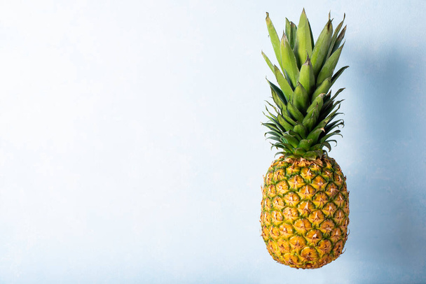 large pineapple on a light blue background - Foto, Imagen