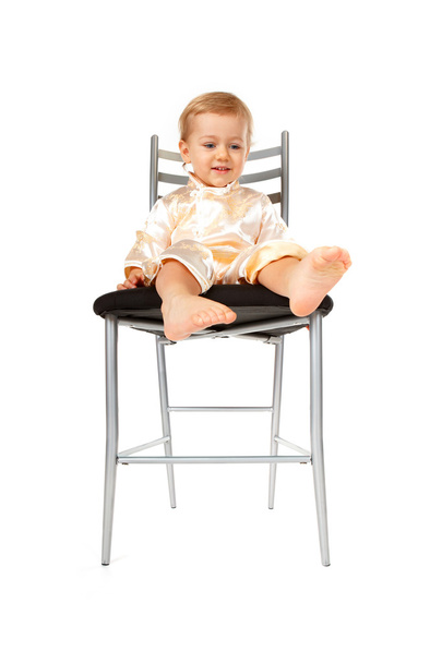 Adorable baby girl sitting on a chair - 写真・画像