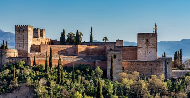 View of Alhambra Palace in Granada, Spain with Sierra Nevada mountains at the background - Photo, Image
