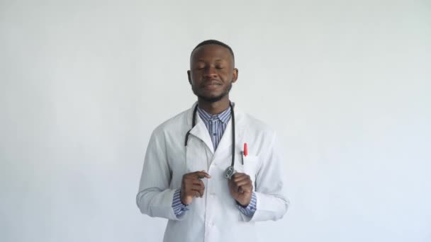Young African doctor happy with the result white background - Materiał filmowy, wideo