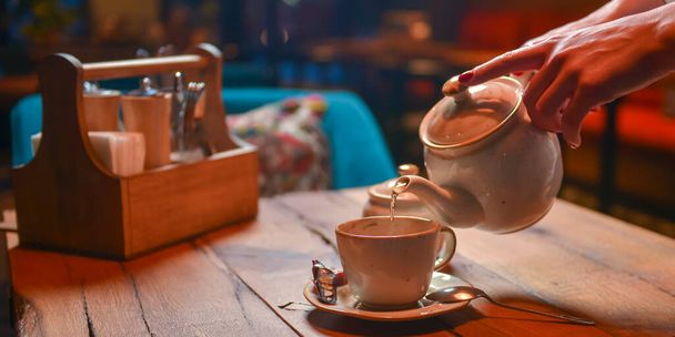 White tea set served on a rustic wooden table in a restaurant. Tea time. Ceramic tea set. Still life, eating out concept. - Zdjęcie, obraz