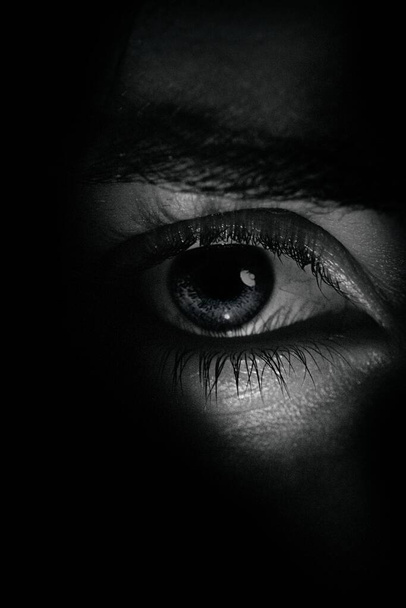 A grayscale vertical  closeup shot of a human eye - Fotoğraf, Görsel