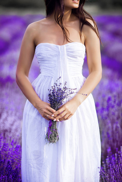 Young beautiful woman in lavender field. Lady on summer background - Foto, immagini
