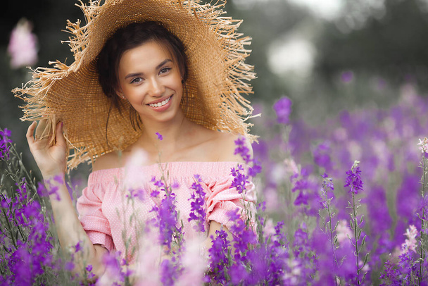 Very beautiful young woman with flowers. Close up portrait of attractive female - Foto, afbeelding