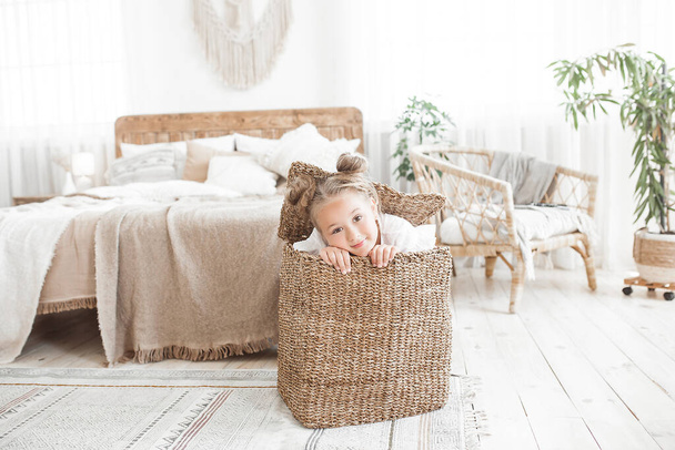 Cute funny little girl close up portrait. Child in the basket - Photo, image