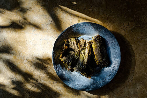 Preserved vine leaves on a metal plate - Valokuva, kuva