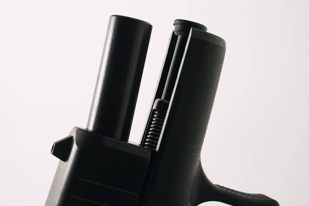 A closeup shot of a pistol barrel and guide rod isolated on a white background - Foto, immagini