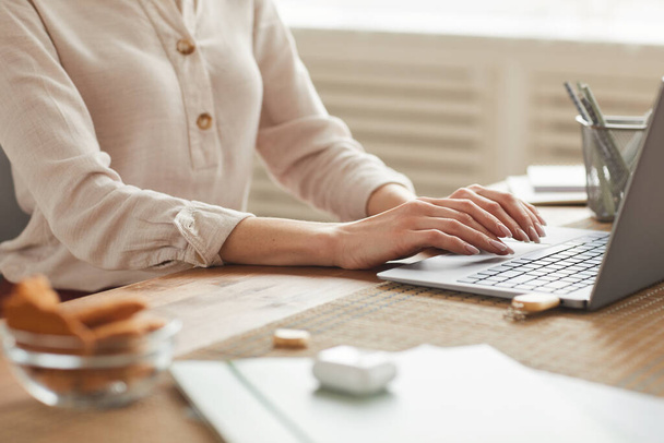 Warm-toned mid section portrait of unrecognizable woman typing on keyboard while working at home office, copy space - Photo, Image