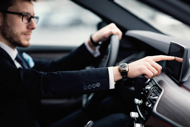 Mężczyzna w okularach siedzi w swoim samochodowym tablicy kontrolnej - Zdjęcie, obraz