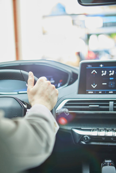 female hands on the steering wheel of a car - Foto, Imagen