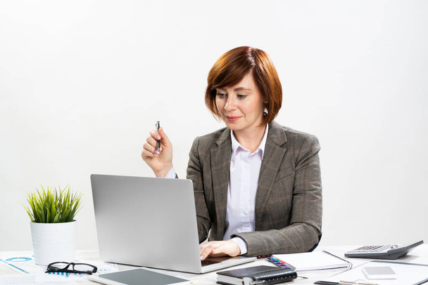 Attractive middle aged businesswoman working - Photo, image