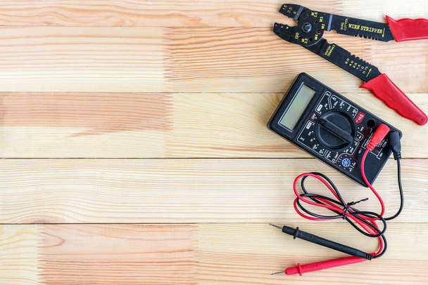 Electrical equipment and tools on wooden table with copy space. - Foto, afbeelding