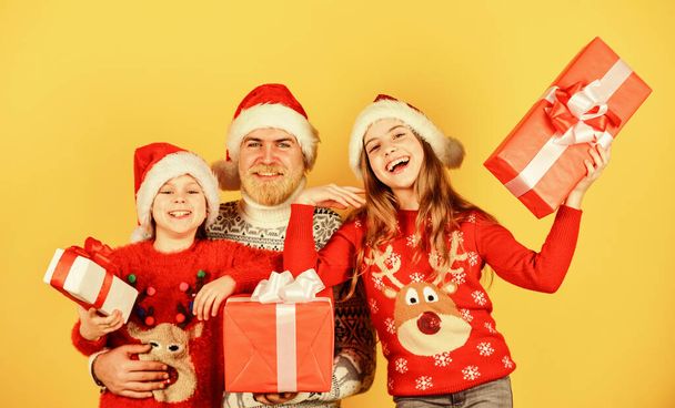time for presents. happy family celebrate xmas. small girls exchange gifts with father. dad love daughters. bearded santa man with kids. knitted fashion for winter. new year shopping - Foto, immagini