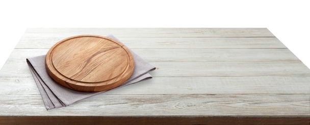 Empty pizza board and tablecloth on wooden deck table with napkin - Фото, изображение