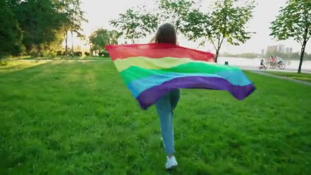 Woman holding rainbow flag, showing tolerance. - Materiał filmowy, wideo
