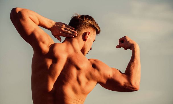 Bigger muscles grow. Increase overall muscle mass. Man muscular chest naked torso sky background. Man muscular athlete bodybuilder show muscles. Bodybuilder shape. Sexy body. Triumph and loss - Φωτογραφία, εικόνα