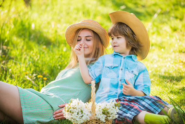 Eco living. Love and respect motherland. Weekend leisure. Explore nature. Spring season. Happy holidays. Cowboy family collecting spring flowers. Mother and son relaxing. Spring holiday. Good vibes - Fotó, kép