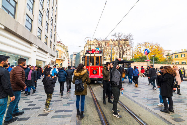 ISTANBUL, TURKEY - DECEMBER 22, 2018: Nostalgic Red Tram of Istanbul. Historic tram in Taksim Istiklal Street. Touristic popular destination Taksim Istiklal Street. Beyoglu, Istanbul, Turkey. - Fotó, kép
