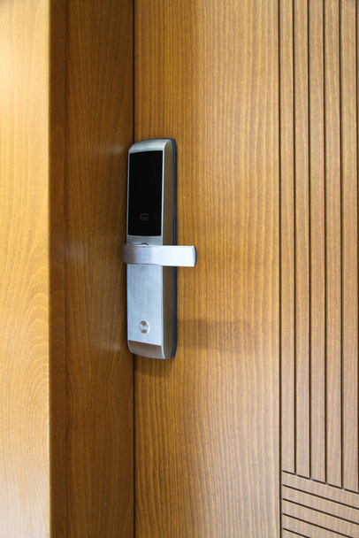 Modern wooden looking front door, security electronic lock system, steel door - Photo, Image