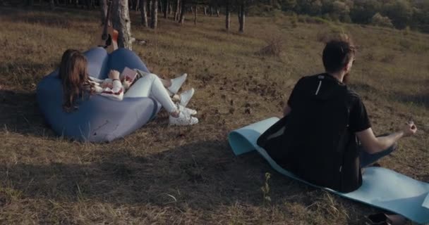 A hipster is meditating in nature - Footage, Video