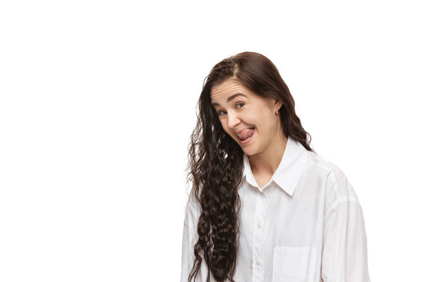 Young caucasian woman with funny, unusual popular emotions and gestures isolated on white studio background - 写真・画像