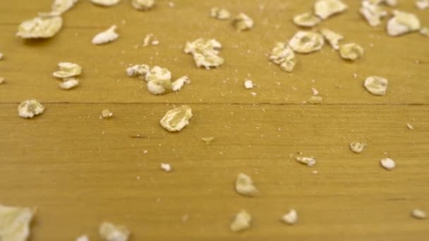 Hercules flakes on a wooden surface. Moving platform with oatmeal macro shot. - Imágenes, Vídeo