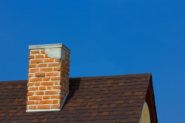 The brick chimney in bright sunlight a deep blue sky horizontal - Photo, image