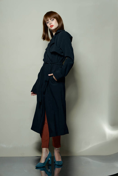 Confident woman model in black coat high heel shoes  - Fotó, kép