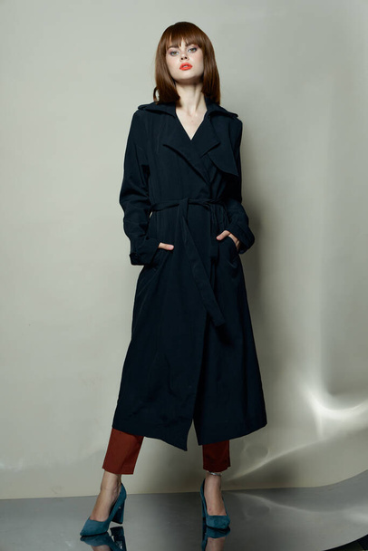  woman in a black coat and blue high heel shoes - Foto, Imagem