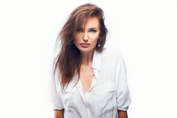 close-up portrait of a beautiful woman on a white background in a light shirt - Foto, afbeelding