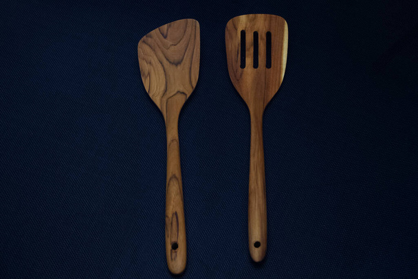 Wood spatula put on black canvas background - Photo, Image