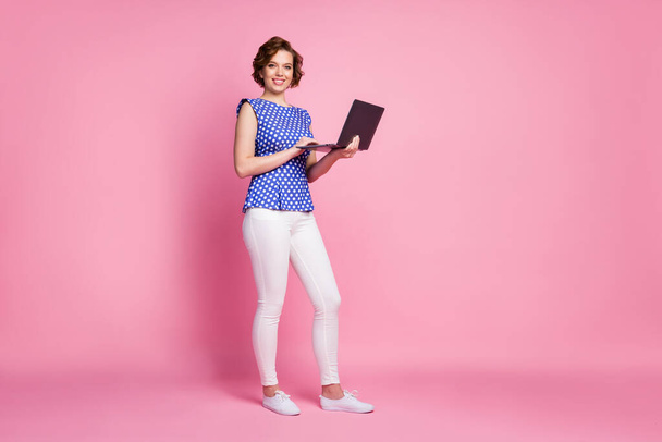 Full length body size view of her she nice-looking attractive lovely cheerful cheery wavy-haired girl holding in hands laptop preparing finance report review isolated on pink pastel color background - Foto, afbeelding