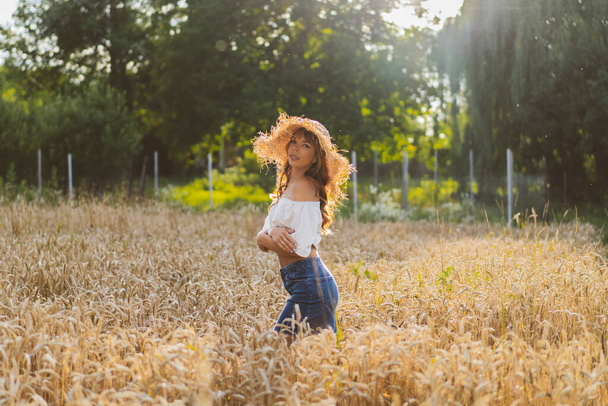 Attractive red-haired girl in a wheat field - Photo, Image