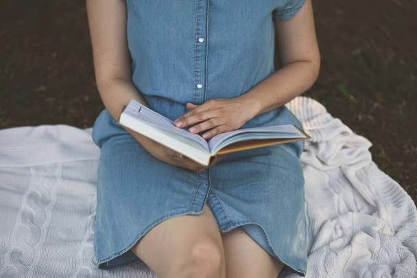 Young woman reading a book in the city park - Photo, image