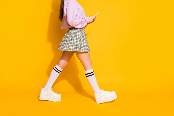 Cropped profile side view photo of girl blogger go walk search gps location on her smartphone wear jumper footwear isolated over bright shine color background - Foto, imagen
