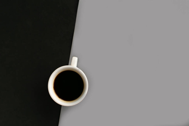 Coffee cup on geometric grey and black background, top view, copy space for the text, minimal concept - Photo, Image