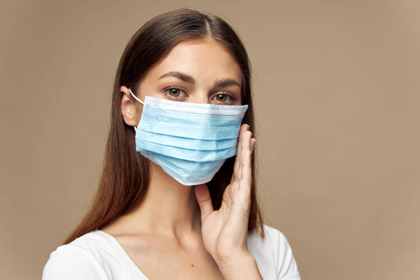 Pretty woman in white shirt in a protective mask health  - Foto, Imagem