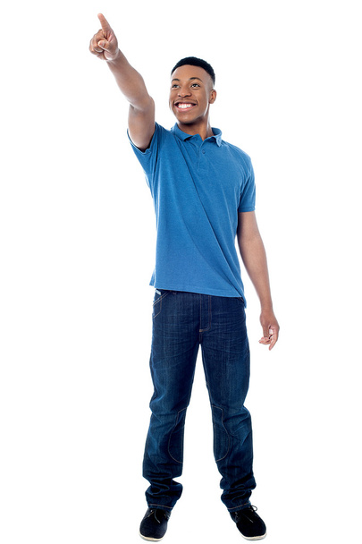 Casual young man pointing away - Fotó, kép